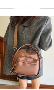 Rear view of brown waterproof nylon crossbody bag with adjustable wide fabric strap