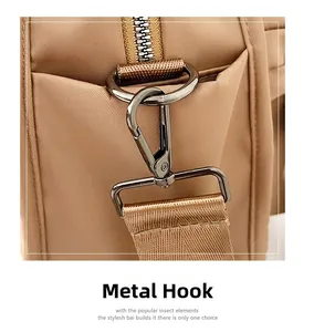 Close-up of durable metal hardware hook and zipper detail on khaki nylon bag