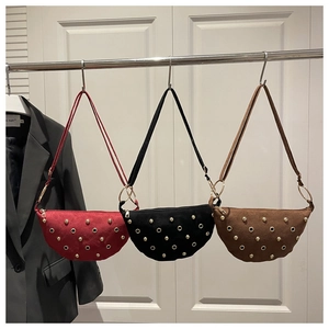 Detailed view of three studded half-moon crossbody bags in red, black, and dark brown colors