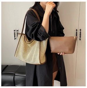 Detail view of woven straw tote bag set with brown leather trim and matching zipper pouch