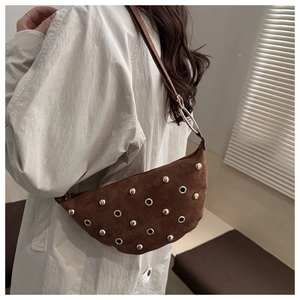 Detail of brown suede crescent bag with gold rivet studs and large metallic ring