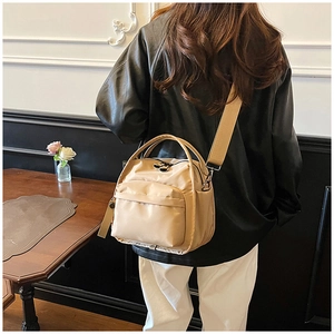 Detail of waterproof nylon bag with adjustable wide strap and front zipper pocket