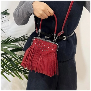 Detail of red tassel shoulder bag with silver studs and vintage kiss-lock closure