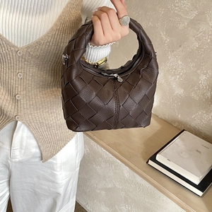 Deep brown woven leather handbag with intricate craftsmanship and silver hardware details
