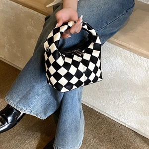 Minimalist black and white checkerboard tote bag with premium leather texture and silver zipper