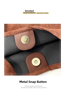 Close-up of golden magnetic buckle on vintage brown suede tote bag with grey lining