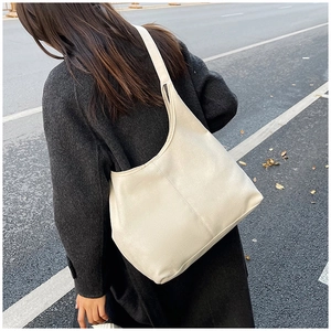 Detail of minimalist beige tote bag made of high-quality faux leather with fine texture