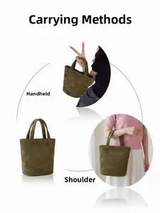 Olive green suede tote bag detail showing dual carry options for handheld and arm wear