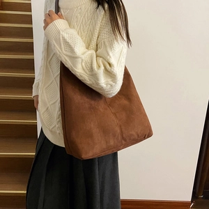 Minimalist brown suede tote bag for women shown with autumn outfit on a model