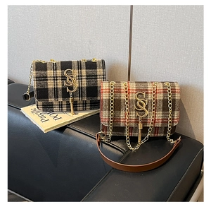 Detail of tweed crossbody bags featuring gold SS logo, tassels and metal chain straps