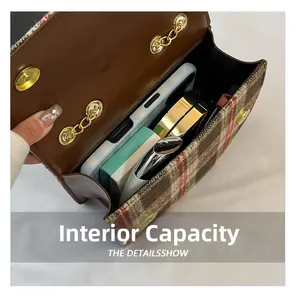 Top view showing internal capacity of plaid handbag with phone and makeup accessories