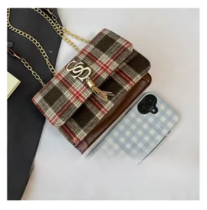 Detail view of mini plaid crossbody bag with gold metal logo and chain strap