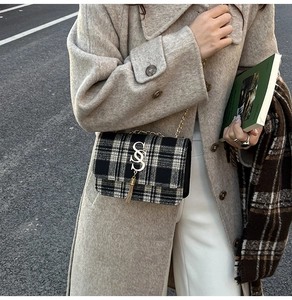 Detail of checkered wool shoulder bag with gold metal SS hardware and tassel charm