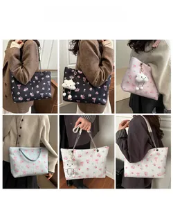 Detail of floral tote bags with pink bows, chain straps and cloud charms in various colors