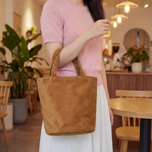 Minimalist brown suede bucket tote bag shown with casual style for college women