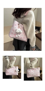 Detail of pink floral tote bag featuring jacquard fabric and cloud pendant decoration
