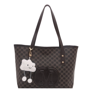 Brown monogram tote bag with M-pattern design and cloud charm on white background