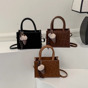 Three leopard print leather tote bags in black and brown with ice cream charms
