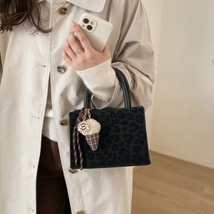 Leopard print baguette shoulder bag with ice cream charm on beige trench coat outfit