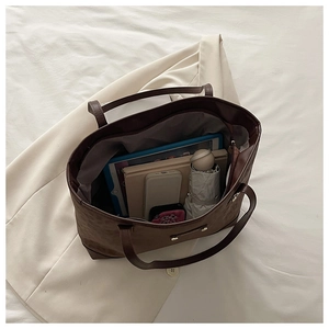 Top view of spacious interior of brown tote bag showing capacity for tablet and daily items