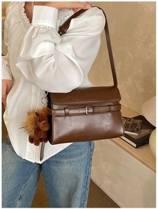 Retro dark brown crossbody bag with a belt buckle design and a small horse pendant