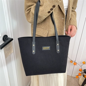 Large capacity black corduroy tote bag with leather straps and minimalist style