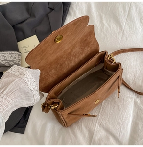 Internal view of brown frosted crossbody bag showing the magnetic closure and large capacity