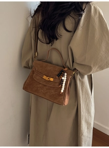 Brown suede textured trapezoid bag with colorful beaded charm and metal hardware