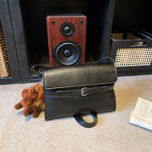 Minimalist black PU leather shoulder bag with silver buckle and brown horse plush charm