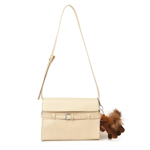Beige leather tote bag with decorative buckle and plush horse charm on white background