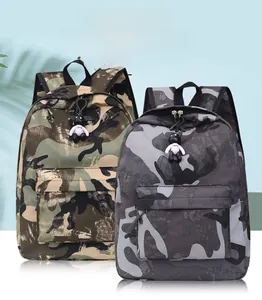 Detail view of nylon camouflage backpacks in green and grey with cute panda pendants