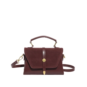 Burgundy faux suede and leather crossbody bag with a vintage gold buckle and top handle