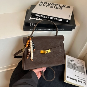 Retro brown textured leather handbag with colorful bead tassel and gold hardware detail