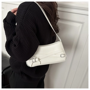 Detailed side view of the white minimalist underarm bag with silver buckle and belt straps