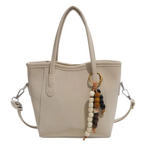 Minimalist beige PU leather bucket bag with wooden bead charm and detachable strap