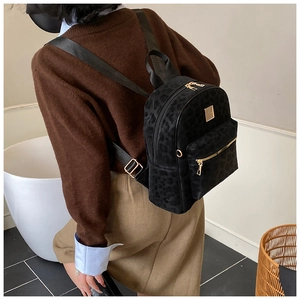 Details des schwarzen Rucksacks mit Leopardenmuster und goldenem Reißverschluss