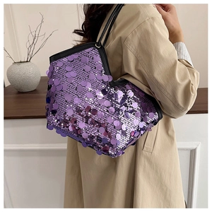Detailed view of shimmering purple sequins on a large tote bag with black handles