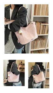 Detail of pink suede tote bag with ice cream charm and metal handle rings