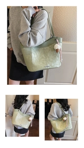 Detail of light green tote bag with vintage faux leather texture and ice cream charm