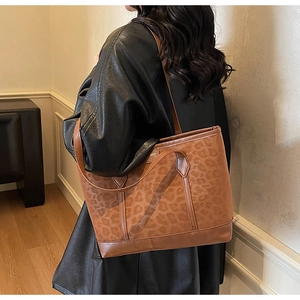 Detail shot of the brown leopard print tote bag with fine stitching and dual straps