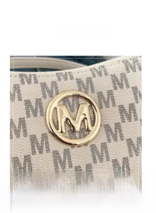 Detail of lychee pattern leather handbag with golden M hardware and monogram print