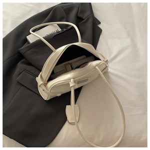 Interior view of cream shoulder bag showing large capacity for cosmetics and essentials