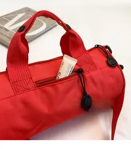 Detail of red travel duffel bag with smooth side zipper pocket for skincare storage