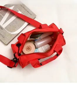 Detailed interior of the red travel bag showing spacious storage with makeup accessories