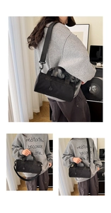 Three-way carry view of a black cylinder gym bag featuring handles and shoulder strap