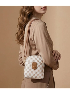 Detailed view of checkered mini crossbody bag with leather flap and gold hardware