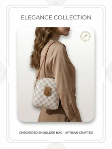 Close-up of checkered shoulder bag with brown leather strap and gold hardware accents