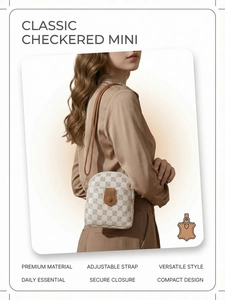 Detailed view of classic checkered mini phone bag with brown leather flap and adjustable strap