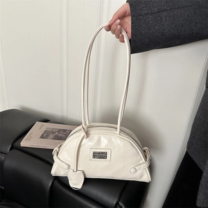 Minimalist white leather half-moon bowling bag for women with polished finish and metal plate