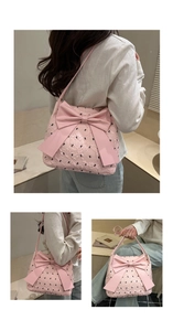 Detail of pink bow tote bag with black embroidery texture and large ribbon decoration